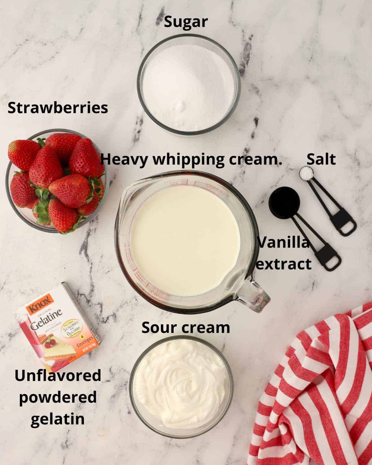 Heavy cream, strawberries, sugar and other ingredients for panna cotta. 