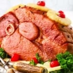 Baked Ham topped with pineapple rings and cherries.