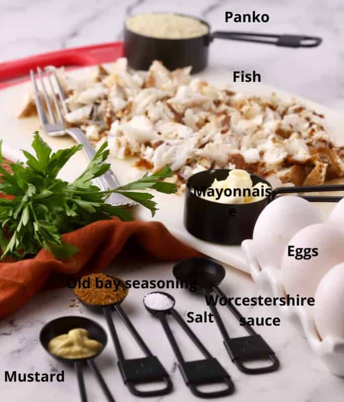 Ingredients to make fish cakes including cooked fish and seasonings. 