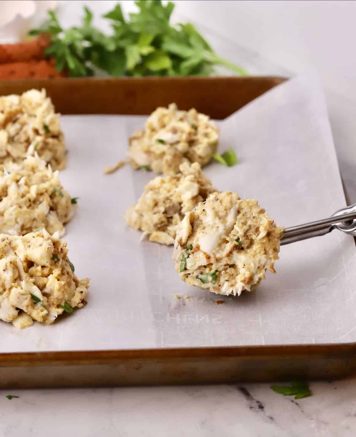 Using an ice-cream scoop to make fish cakes. 