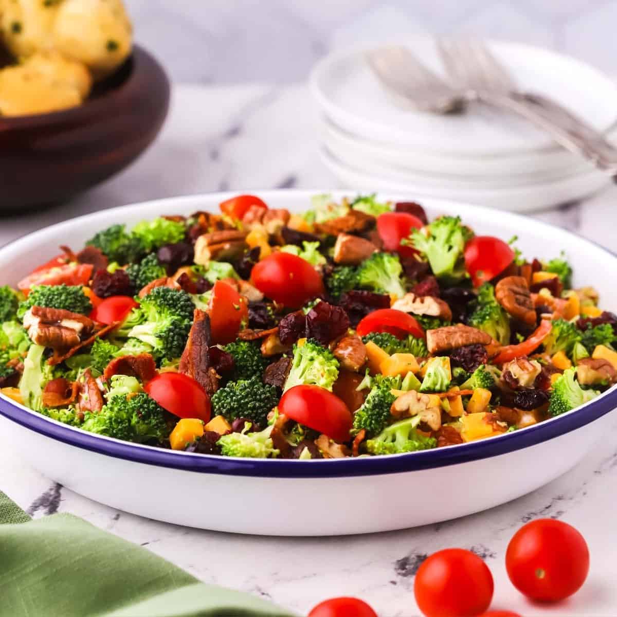 Southern Broccoli Salad in a white metal bowl with a blue rim.