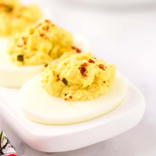 Southern deviled eggs on a white egg plate.