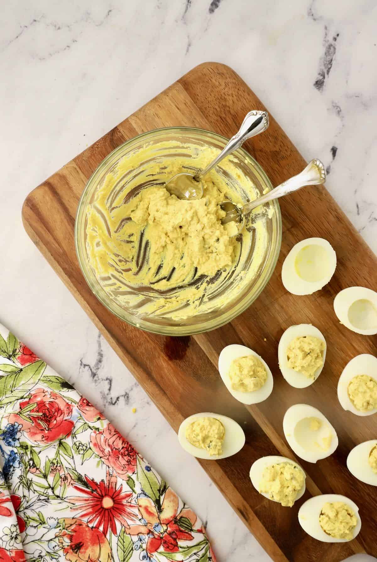 Filling deviled eggs with the yolk mixture. 