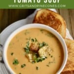 Pinterest pin showing a bowl of roasted tomato soup topped with croutons.