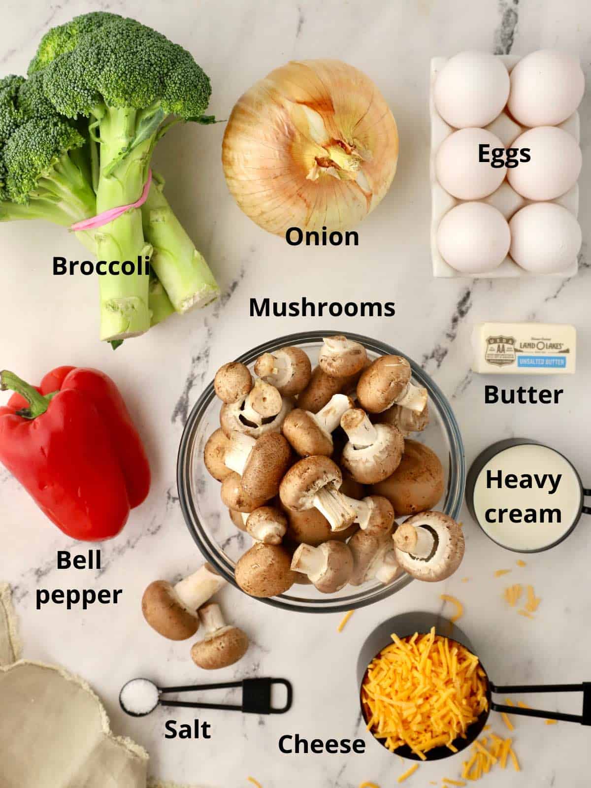 Fresh mushrooms, broccoli and other ingredients for a mushroom broccoli frittata.