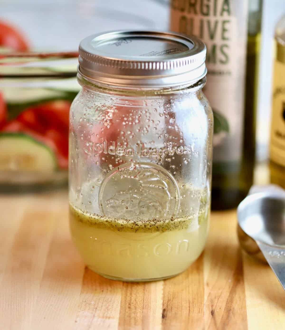 A mason jar full of homemade salad dressing.