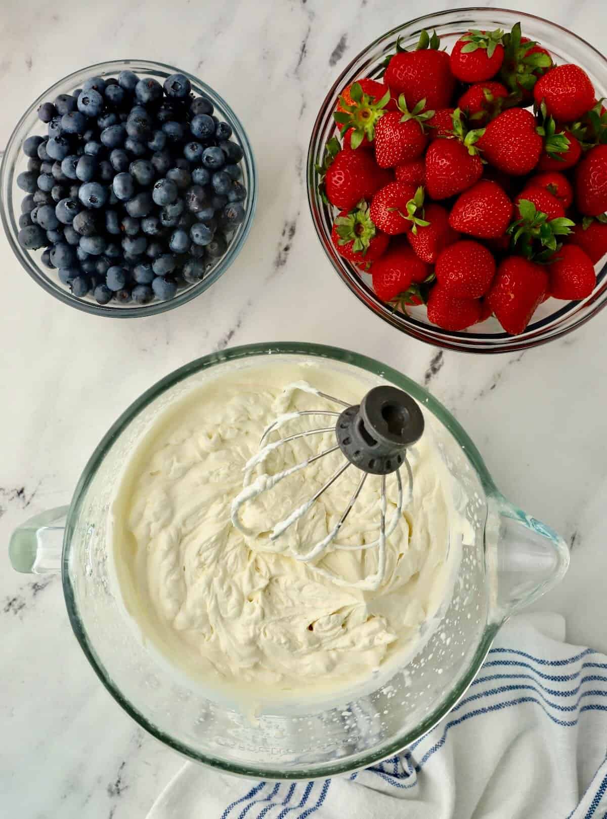 A mixing bowl full of whipped cream. 