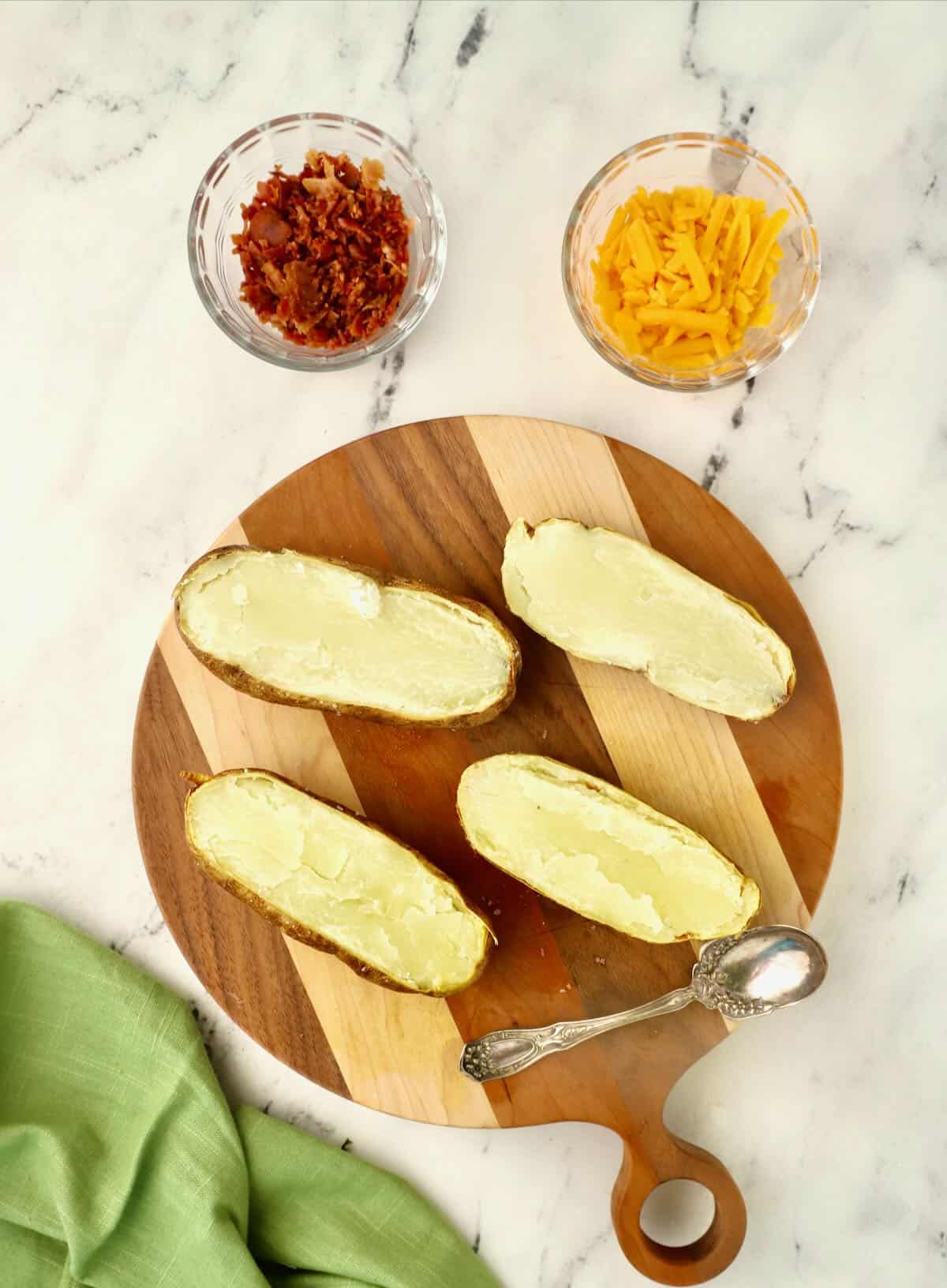 Two baked potatoes sliced in half. 