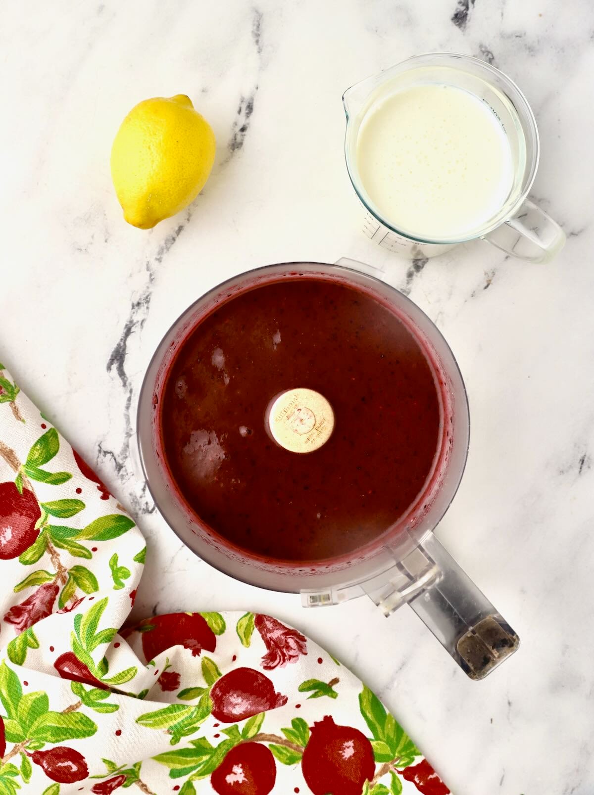 A food processor bowl full of berry puree. 