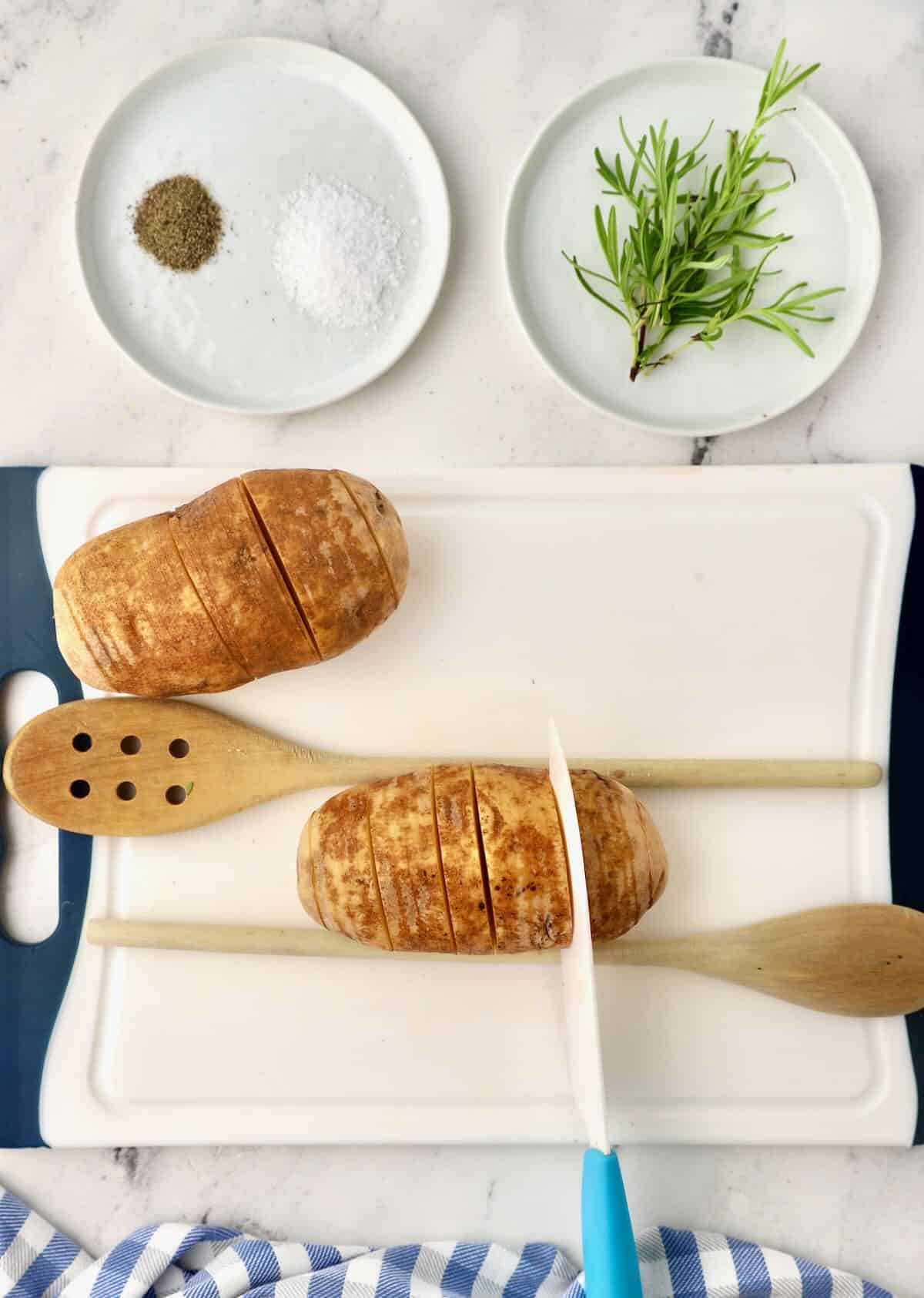 Using a knife to slice a potato into thin slices. 