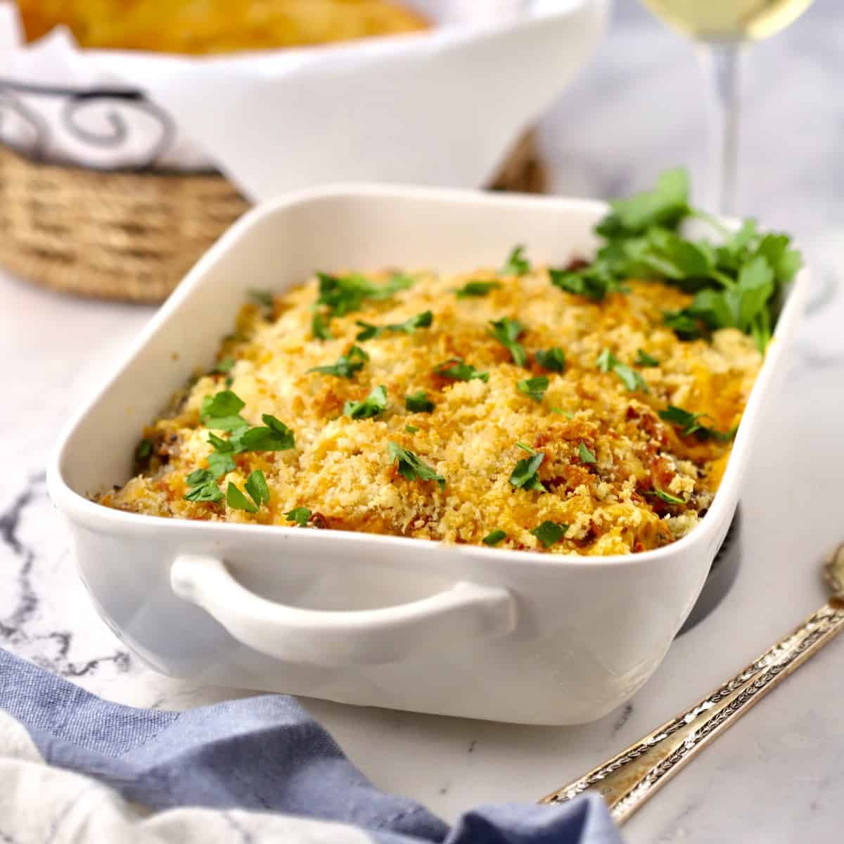 Chicken, sausage, and wild rice casserole in a white baking dish.