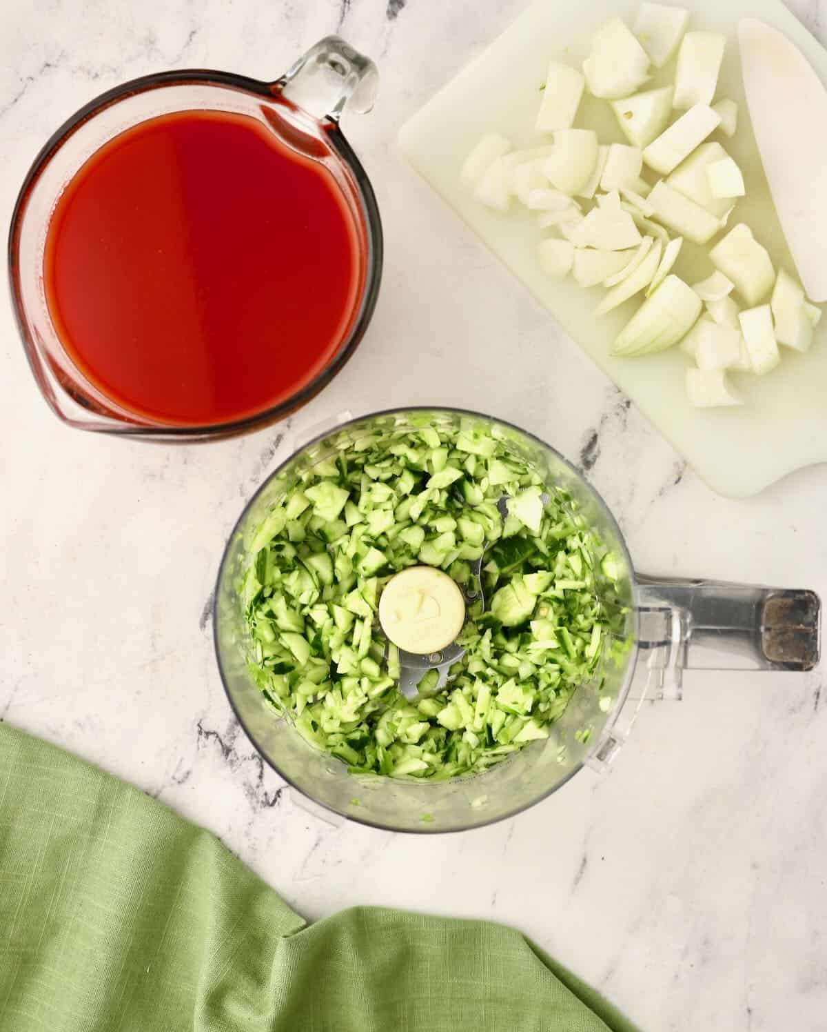 Chopped cucumber in the bowl of a food processor. 