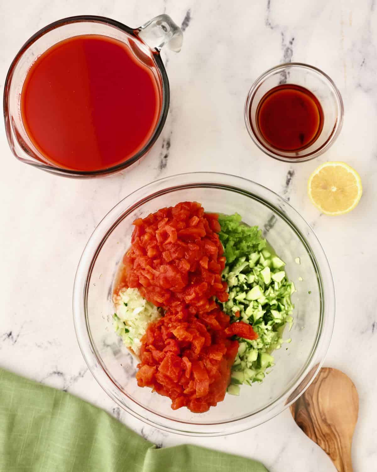 Canned tomatoes and other chopped vegetables in a bowl. 