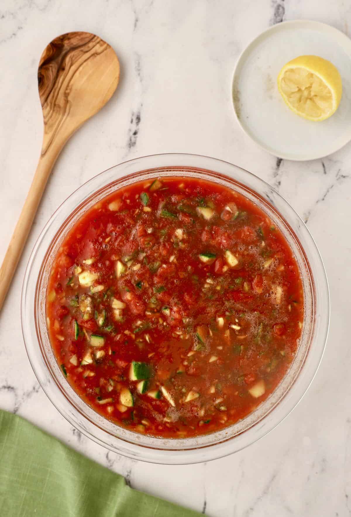 A large glass bowl full of gazpacho. 