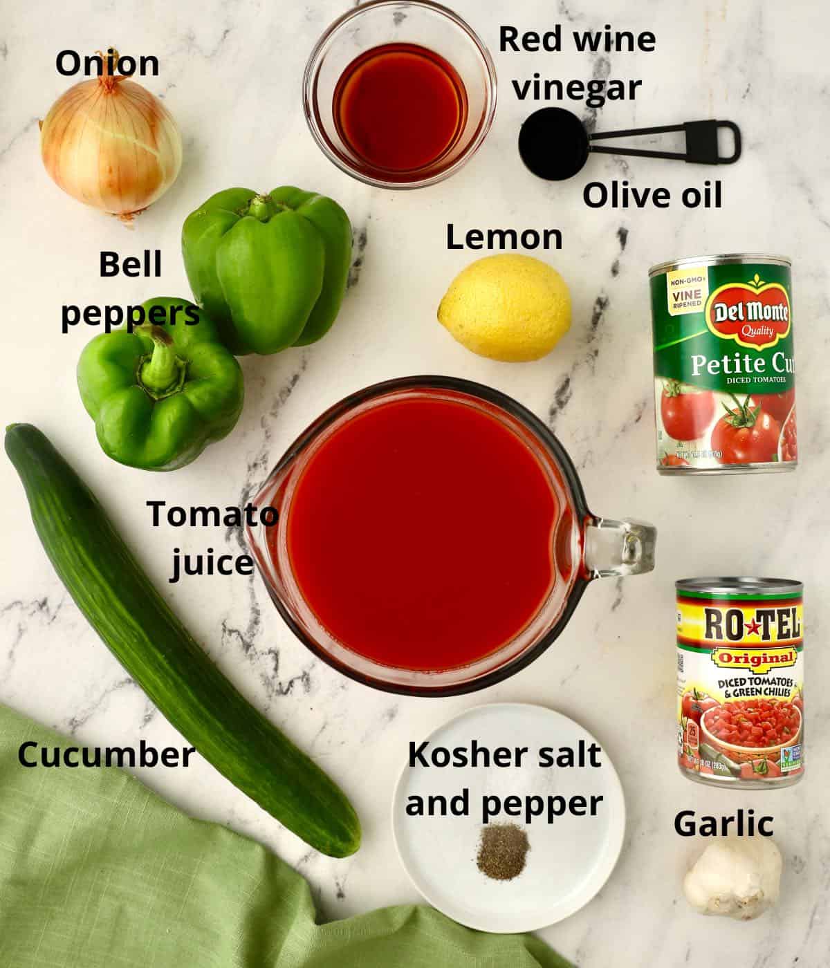 Ingredients to make gazpacho including tomato juice, cucumber and canned tomatoes. 