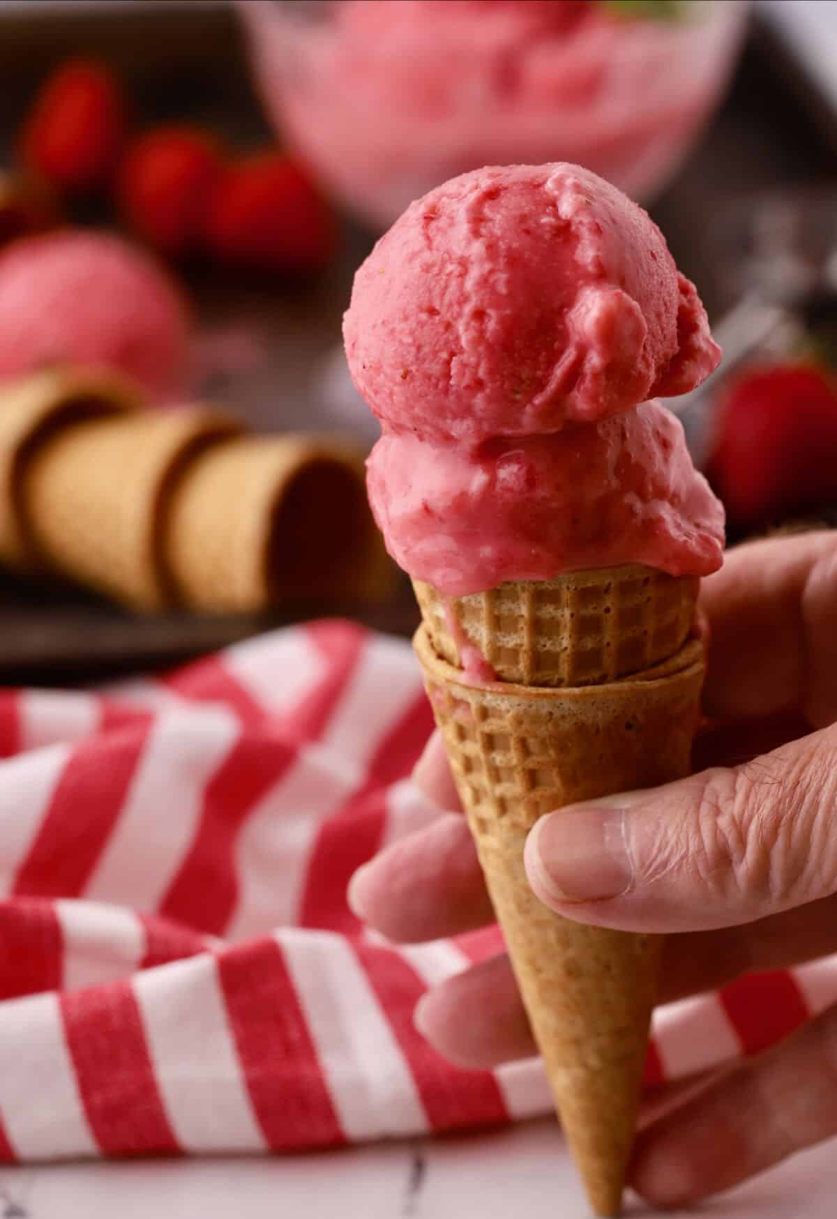 Strawberry sherbet in an ice cream cone.