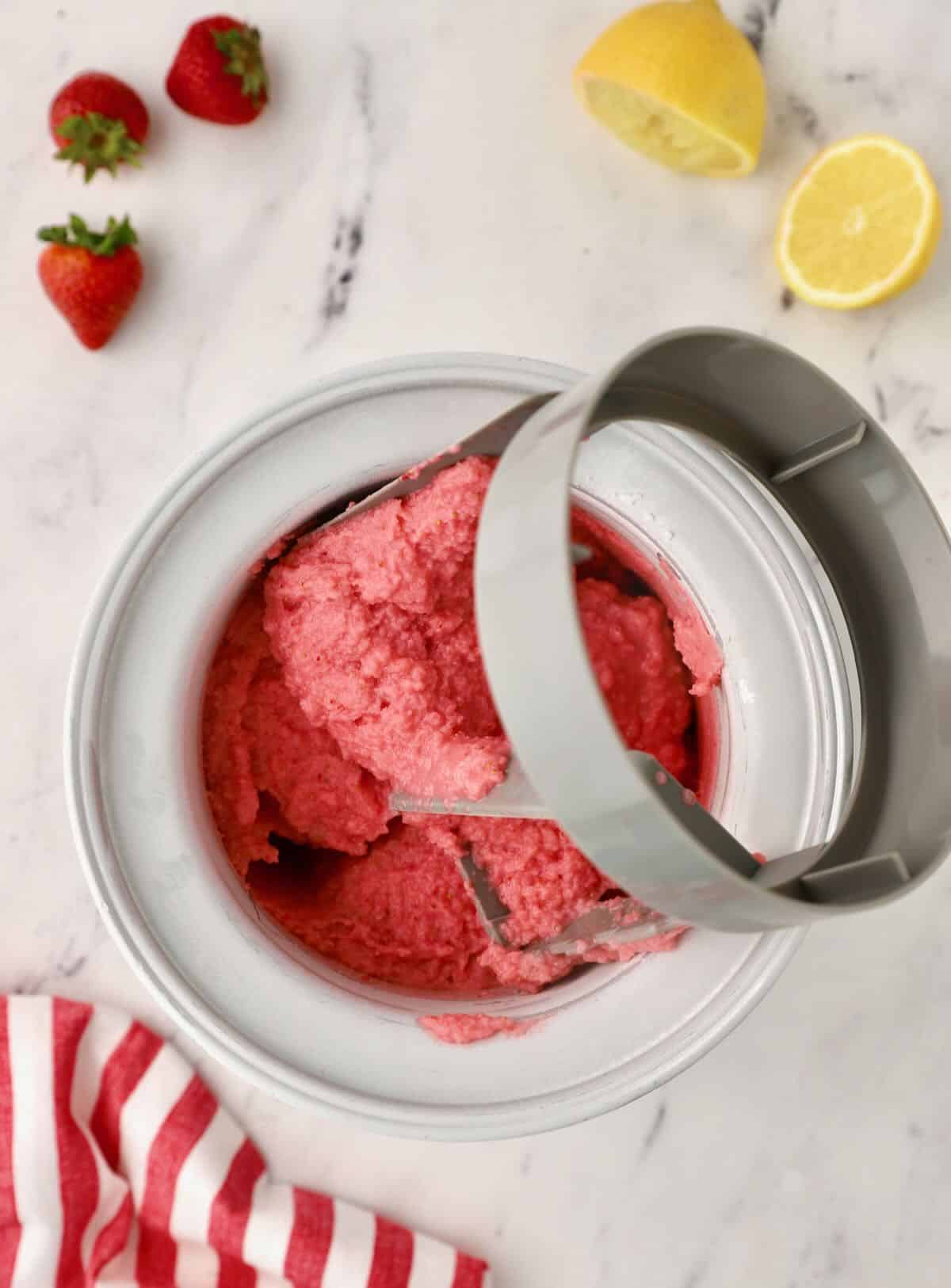 An ice cream maker with strawberry sherbet. 