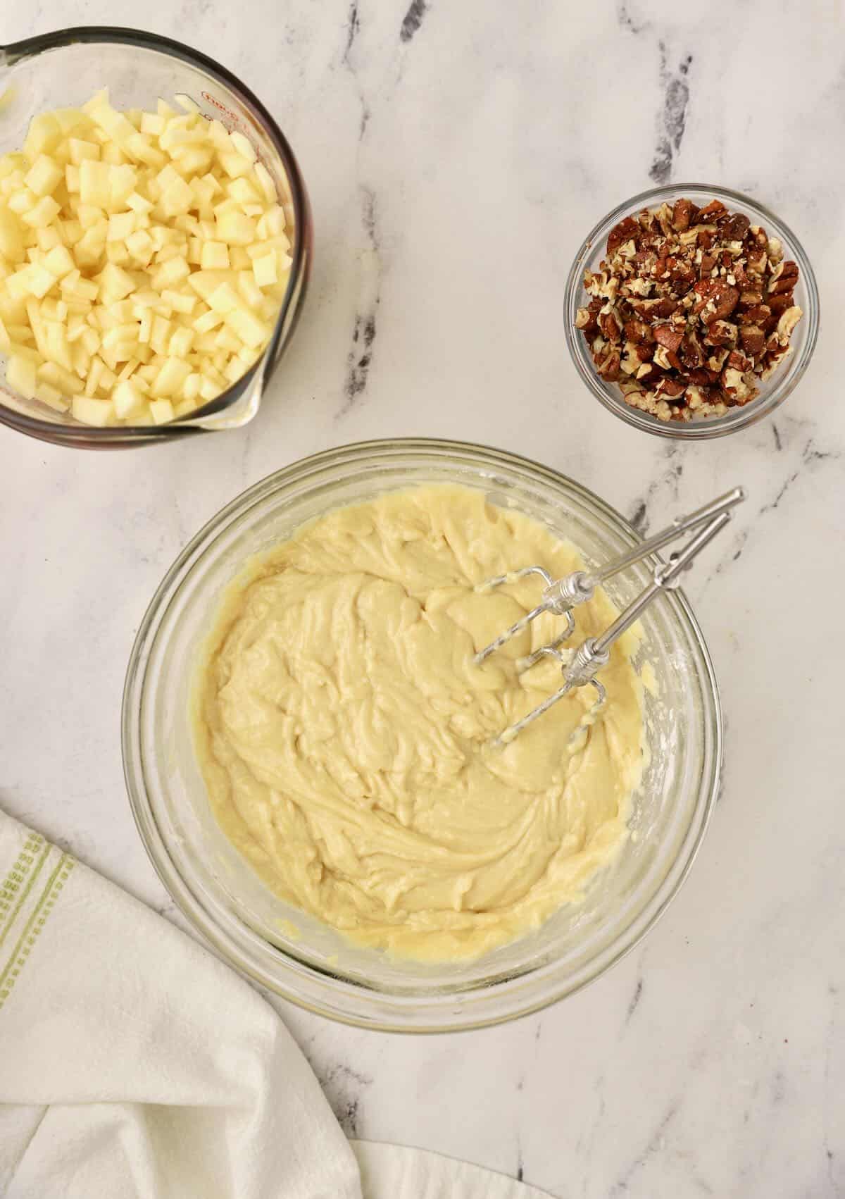 Cake batter in a clear glass bowl. 