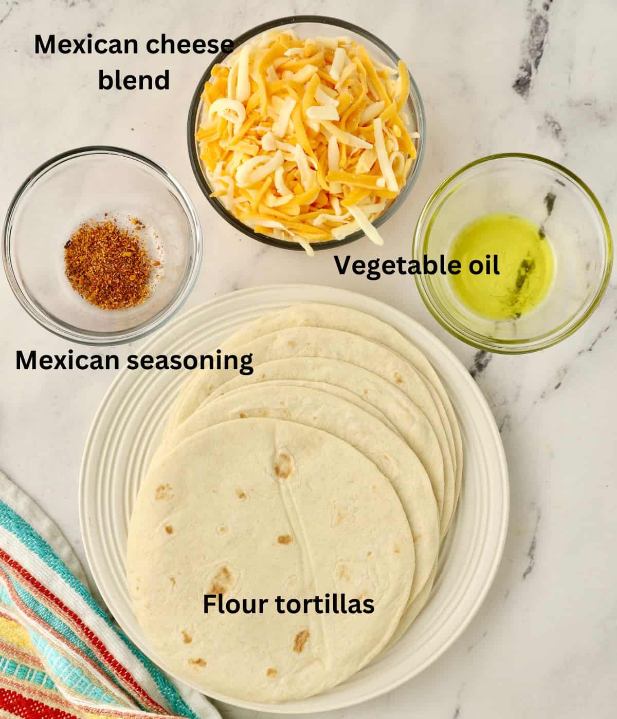 Flour tortillas, cheese, Mexican seasoning and oil in a cup.