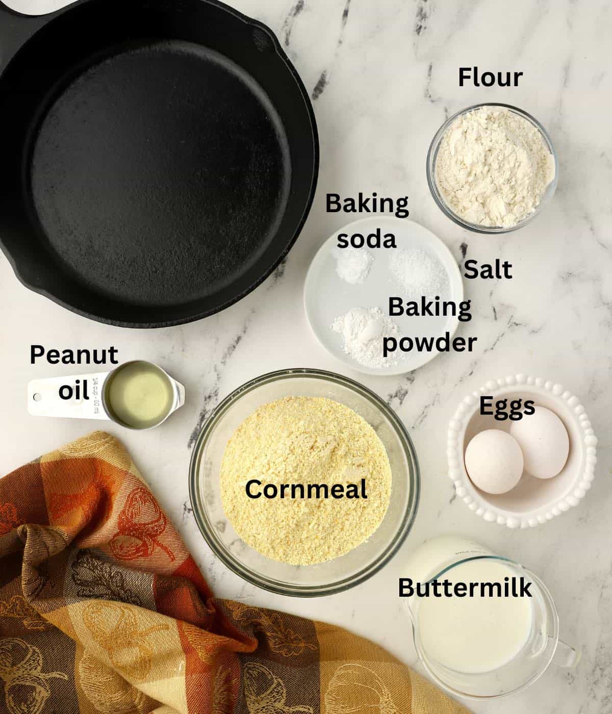 Ingredients for cornbread including cornmeal, flour and buttermilk.