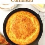 Golden brown cornbread in a cast iron skillet.