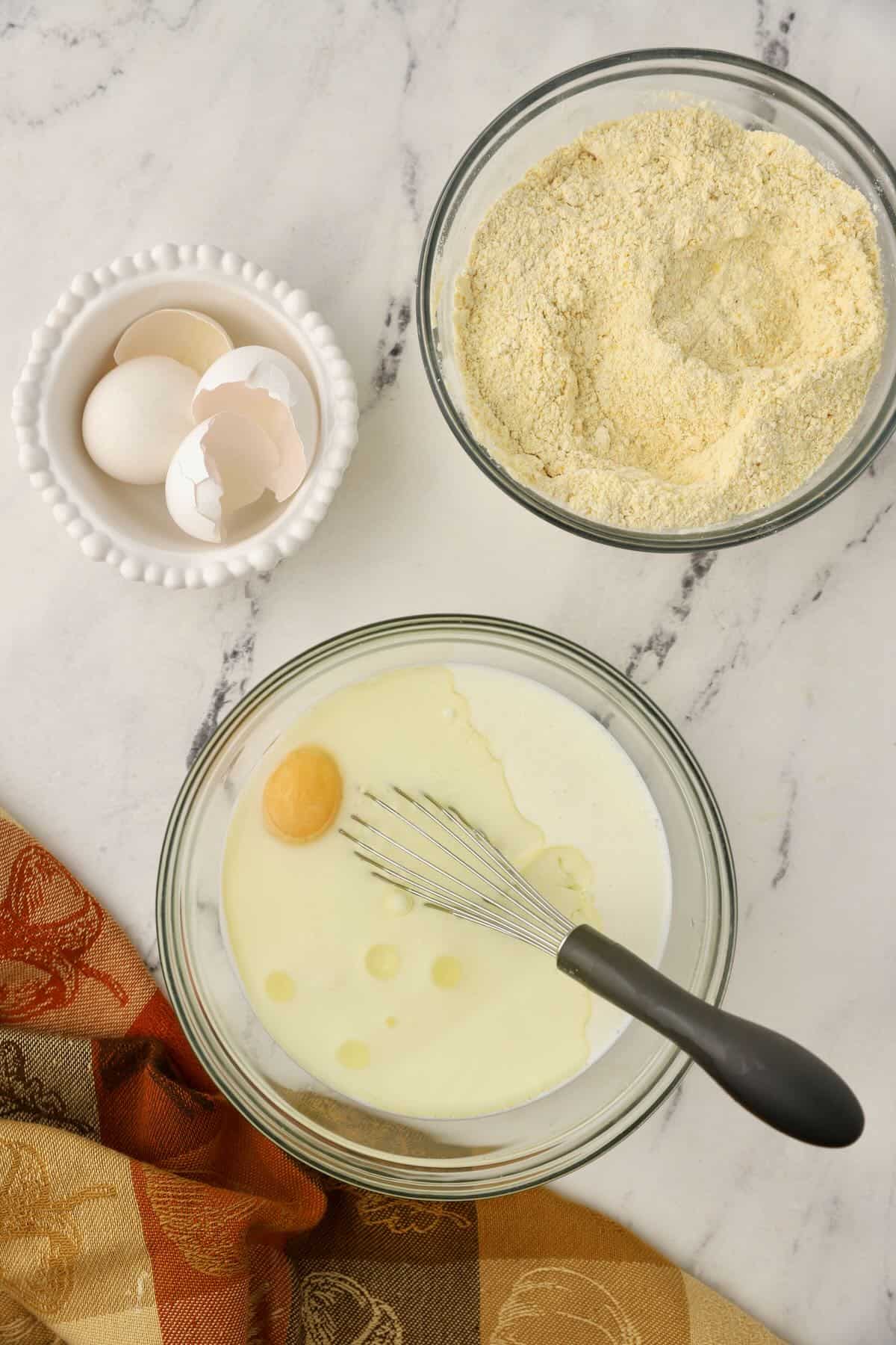 Buttermilk, eggs, and oil in a clear glass bowl. 