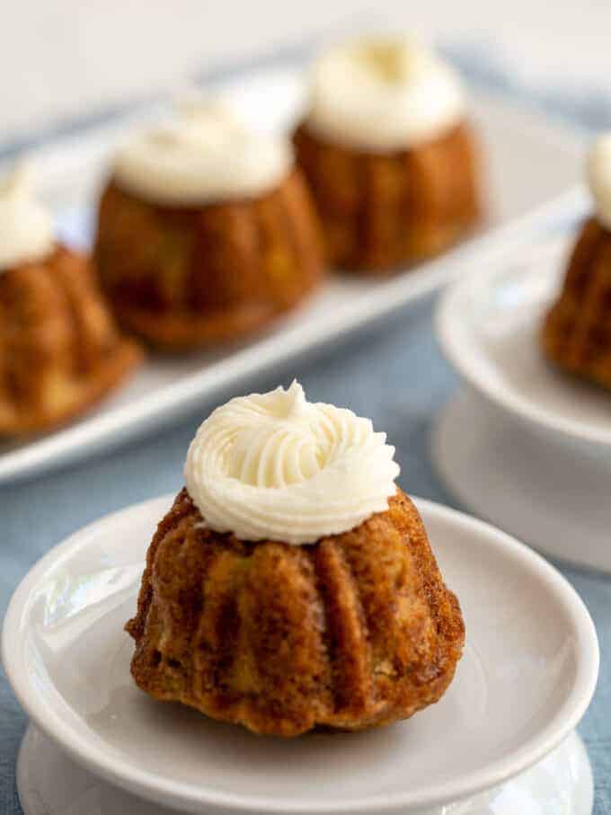 Mini bundt cakes topped with cream cheese frosting. 