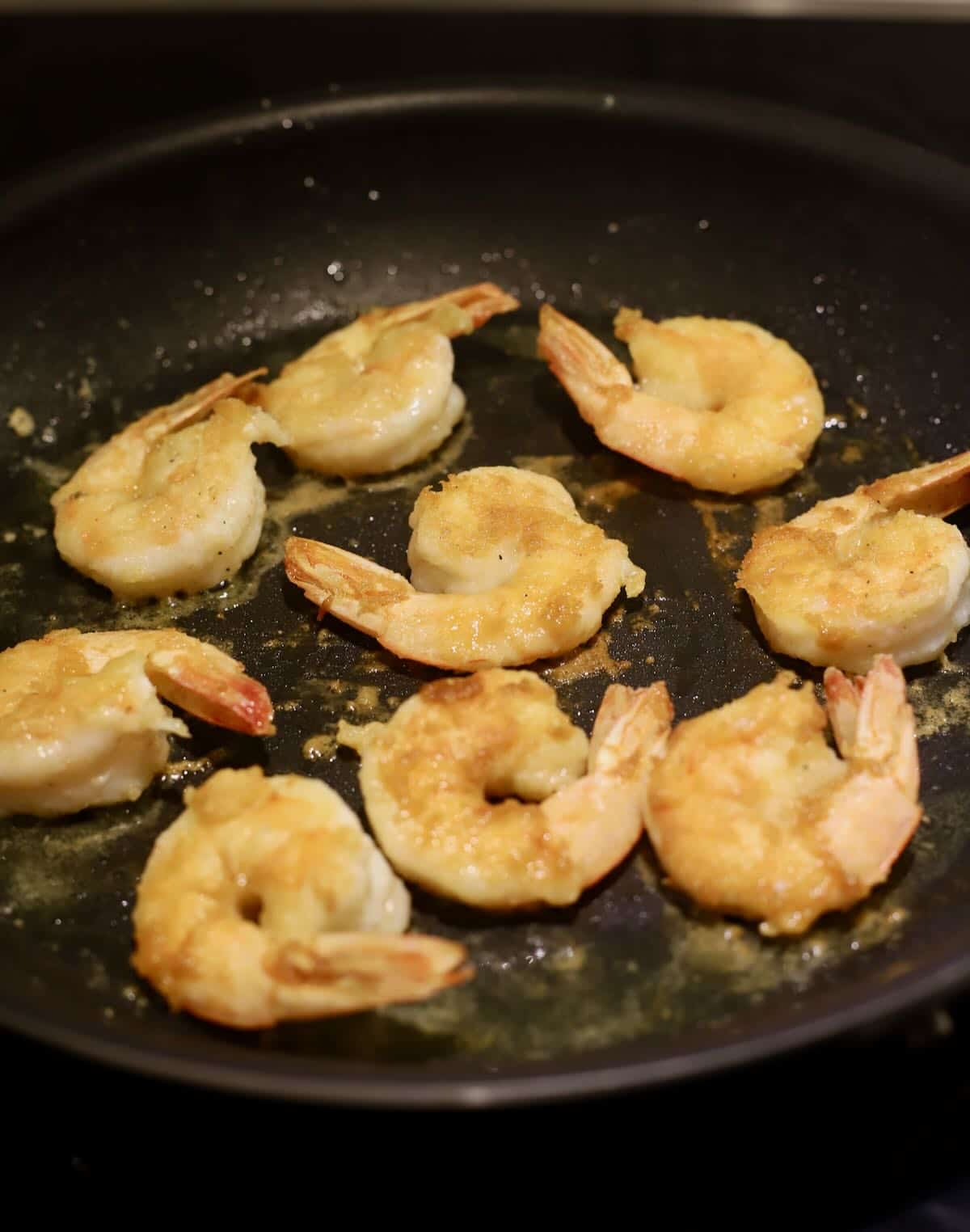 Shrimp frying in a skillet. 