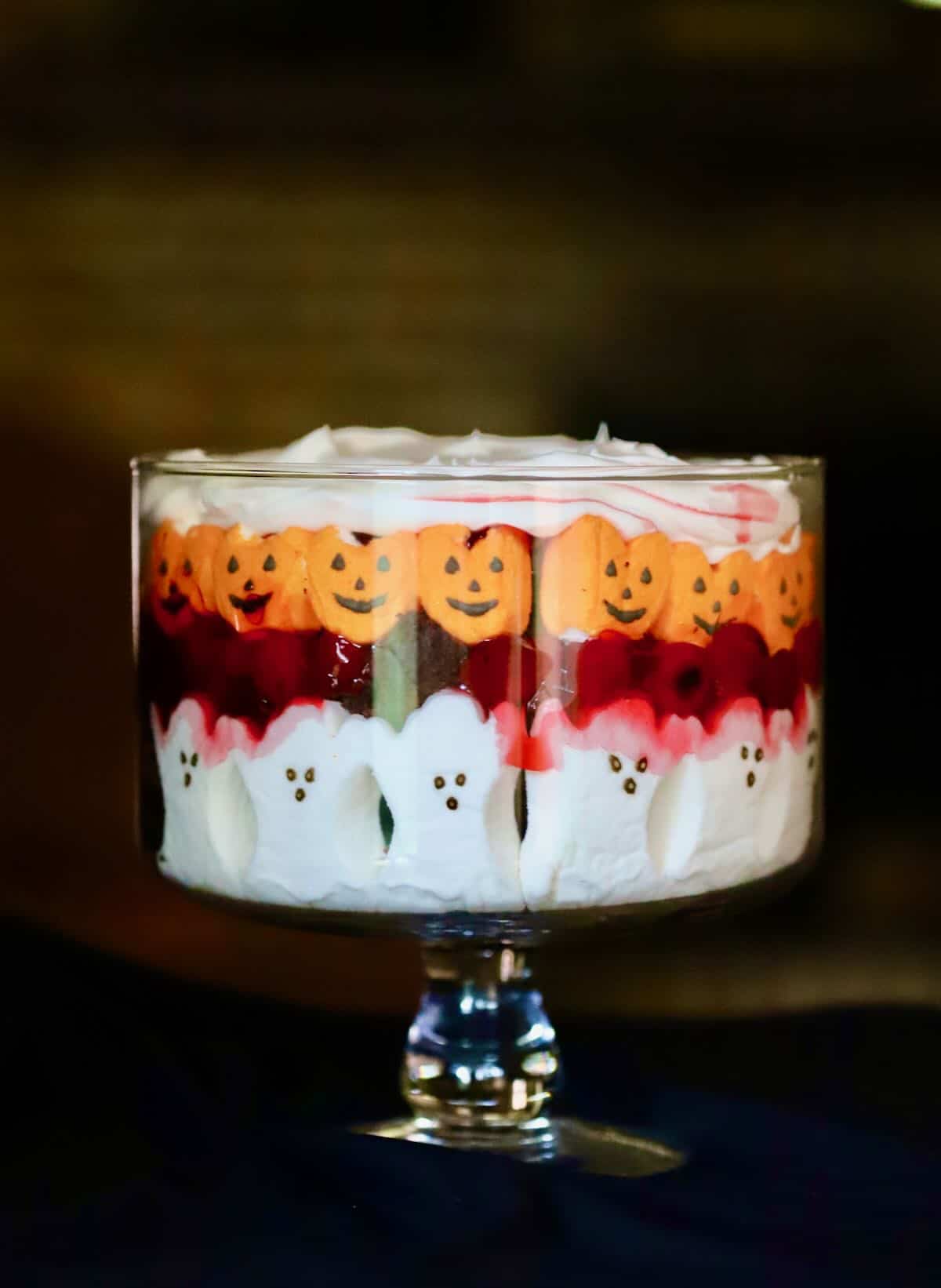 A Halloween trifle with layers of chocolate cake, cherry pie filling and peeps. 