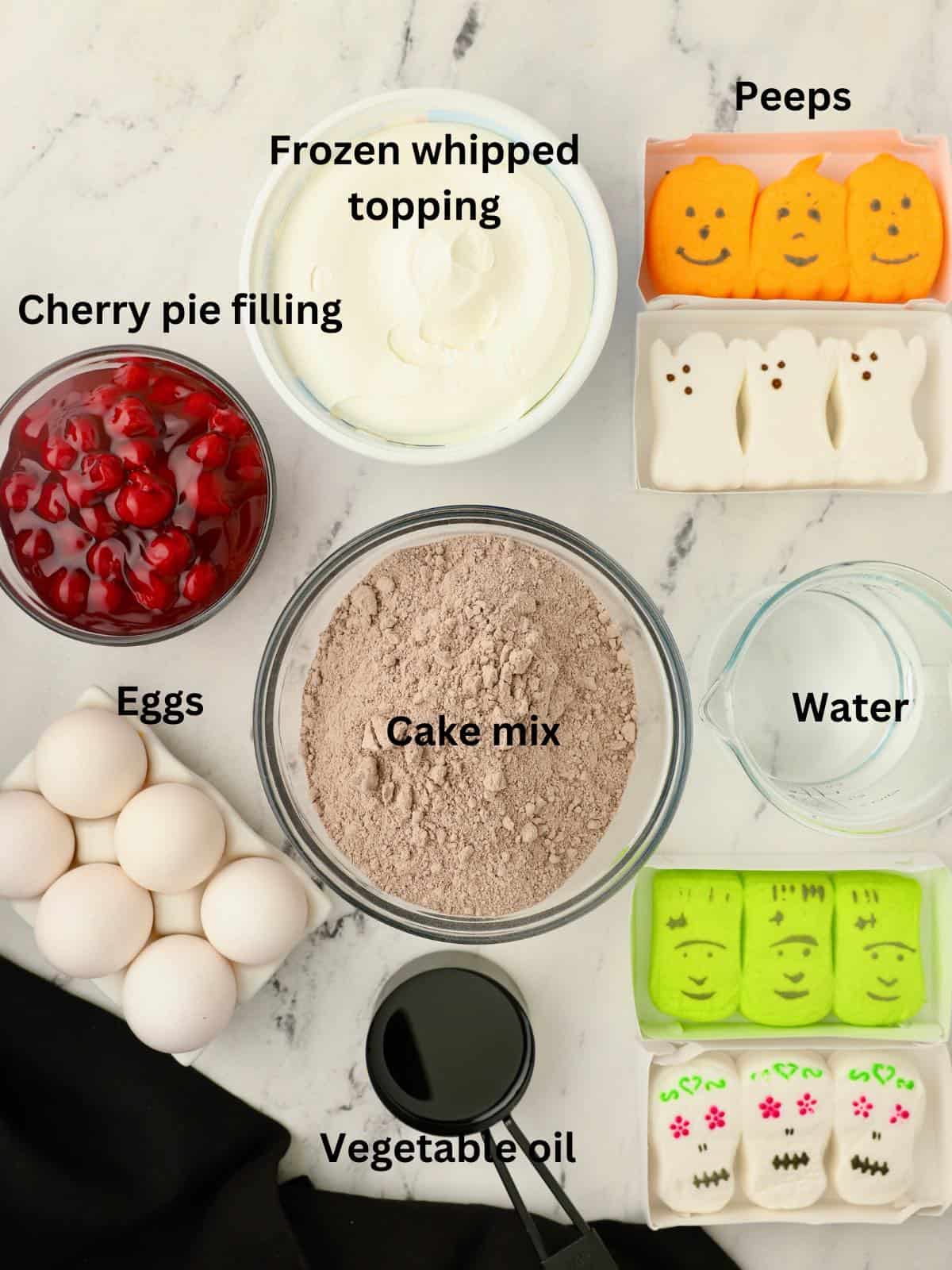 Ingredients for a trifle including cake mix and cherry pie filling. 