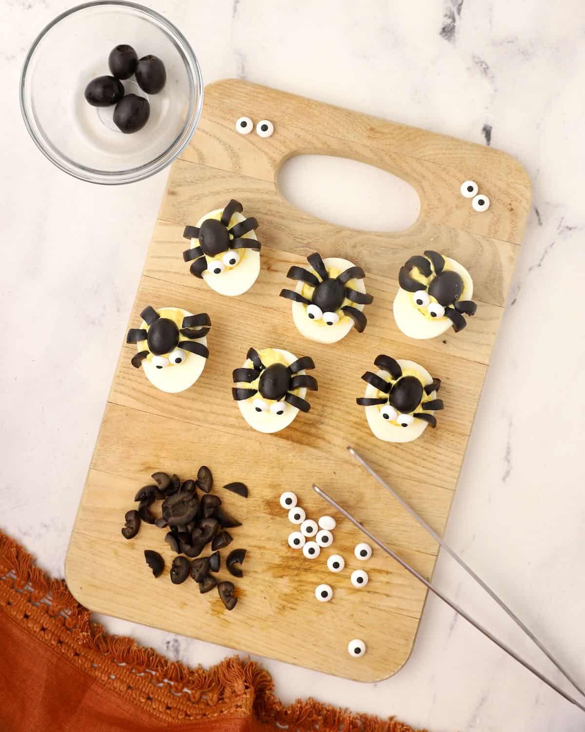 Halloween deviled eggs topped with black olive spiders. 