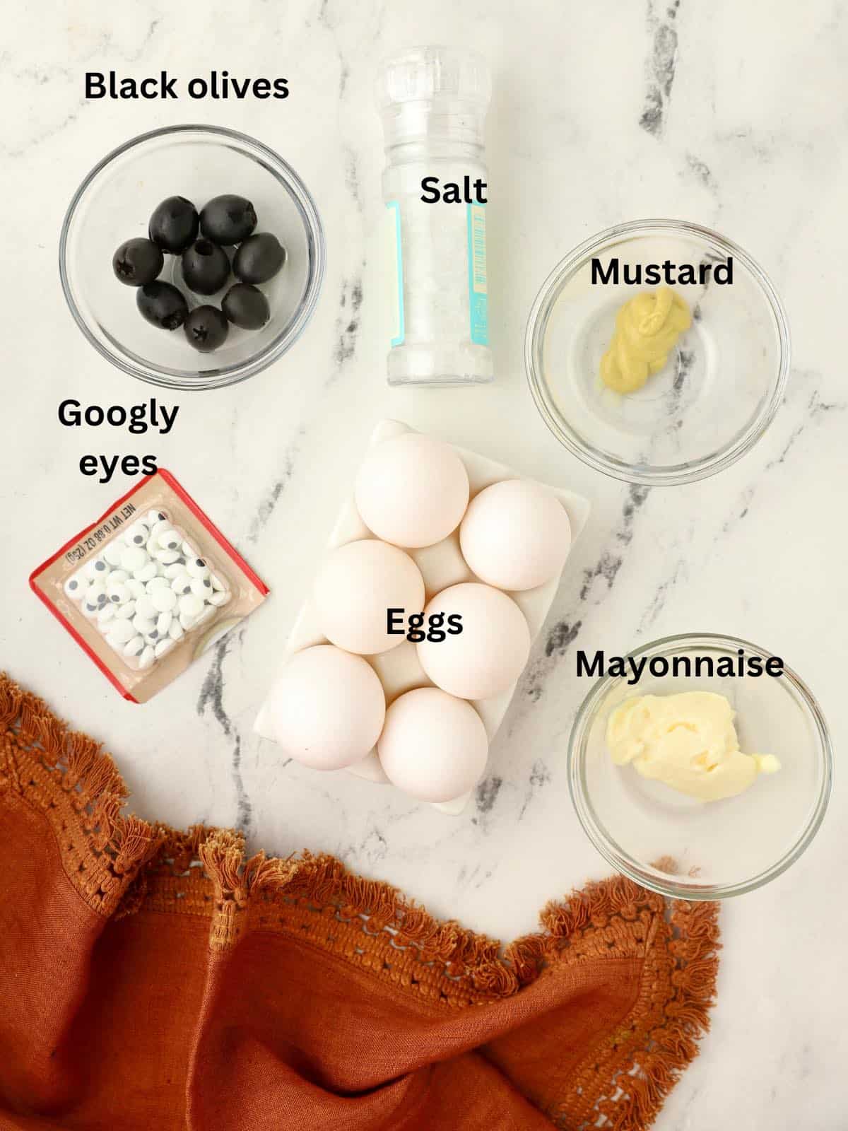 Deviled egg ingredients for Halloween with googly eyes. 