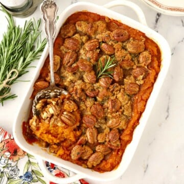 A rectangle white baking dish full of sweet potato casserole.