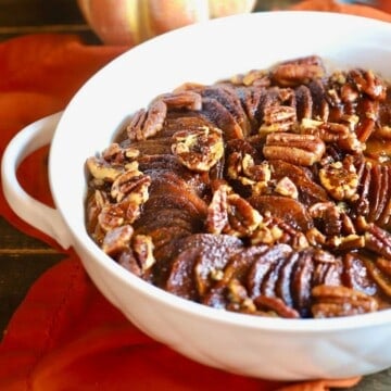 A white casserole dish with candied sweet potatoes.