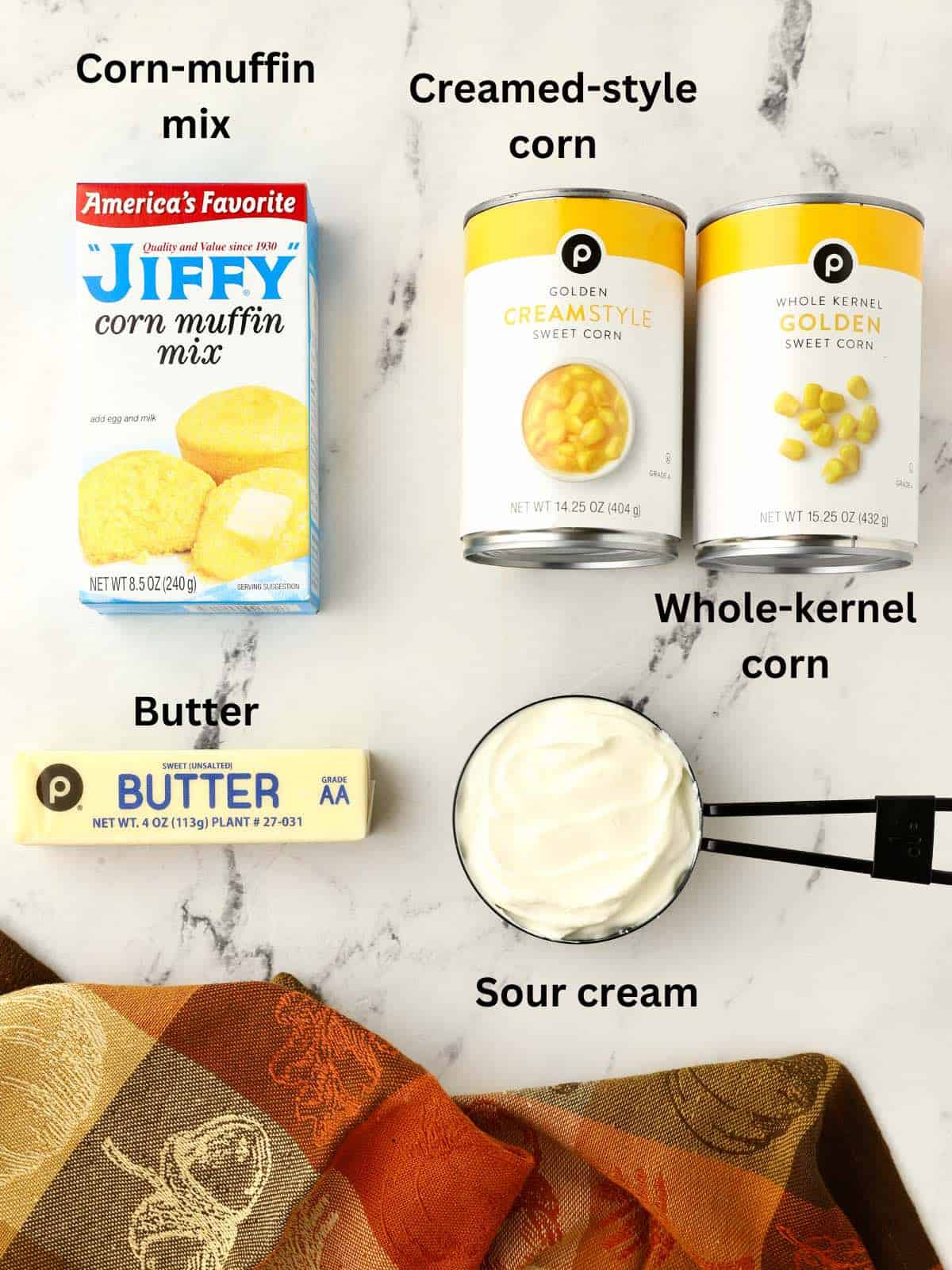 Cans of corn, muffin mix, butter and a cup of sour cream. 