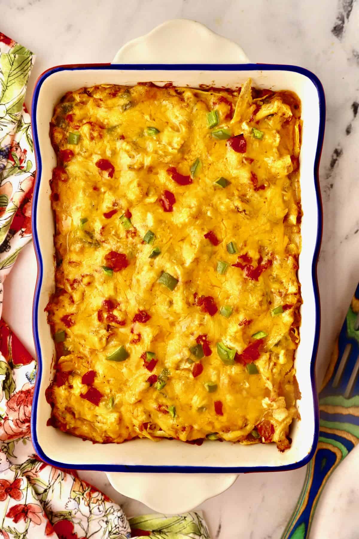 A baked King Ranch Chicken Casserole in a multi-colored baking dish.