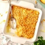 Pineapple cheese casserole topped with crushed Ritz crackers in a white baking dish.