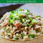 A large bowl full of white rice, topped with black-eyed peas, and garnished with parsley.