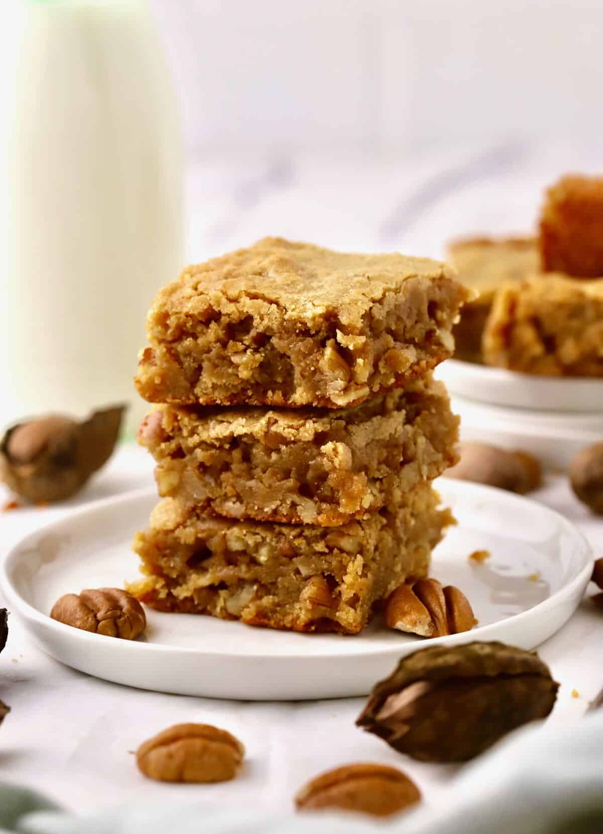 A stack of dessert bars on a white plate. 