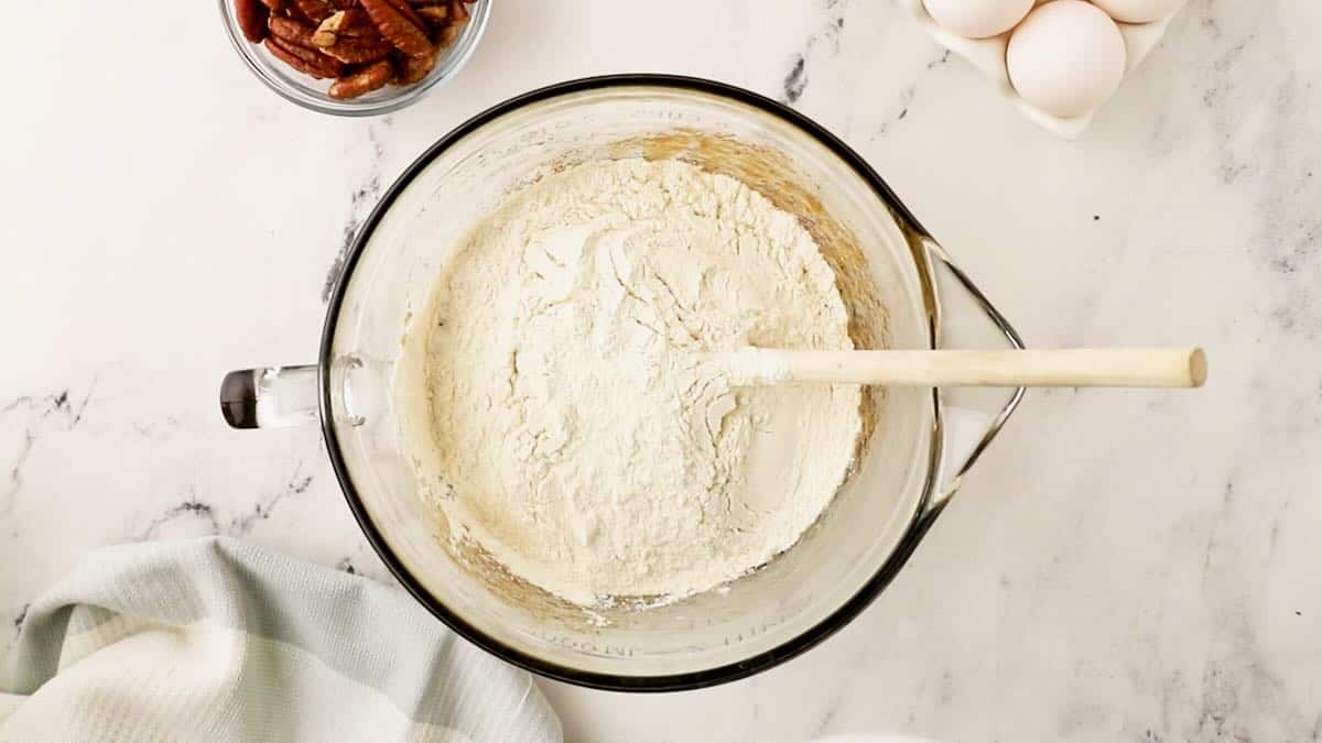 Flour being added to cookie bar batter. 