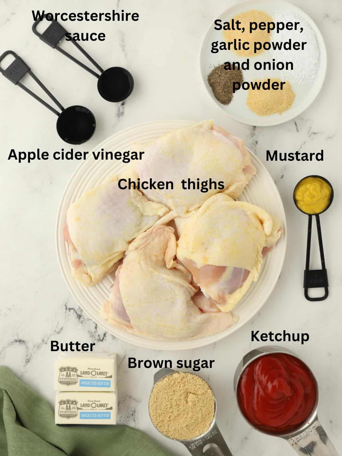 Ingredients to make oven baked BBQ chicken including chicken thighs and BBQ sauce. 