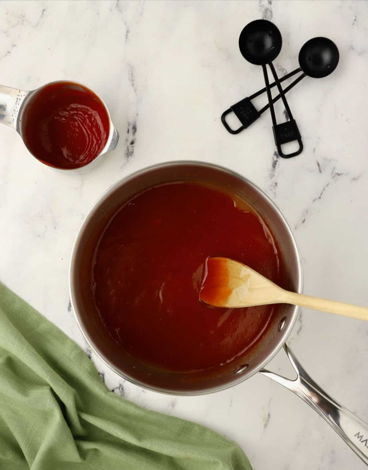 A saucepan full of barbecue sauce. 