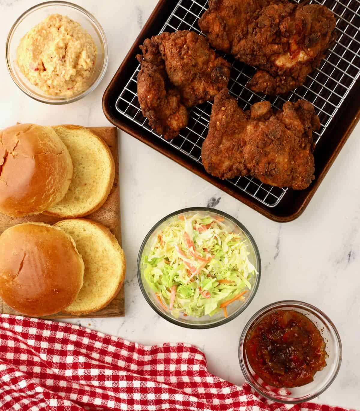 Toasted buns, fried chicken, coleslaw, pimento cheese and bacon chutney. 
