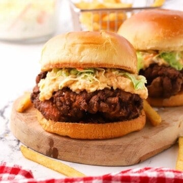 Fried chicken burger topped with coleslaw and pimento cheese.