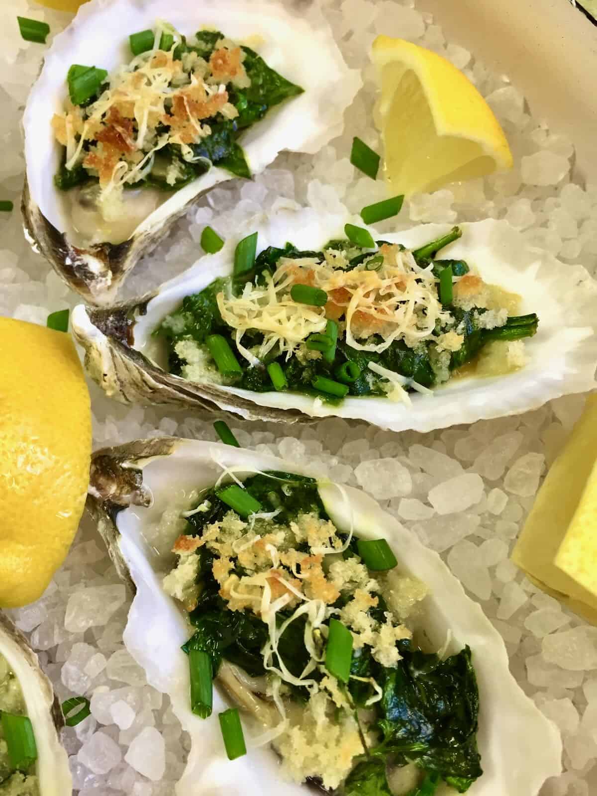 Oysters Rockefeller Casserole (oysters, rockefeller, casserole, blend spinach parmesan cheese, blend spinach parmesan cheese garlic, blend spinach parmesan cheese garlic butter) Three baked oysters topped with spinach and panko.