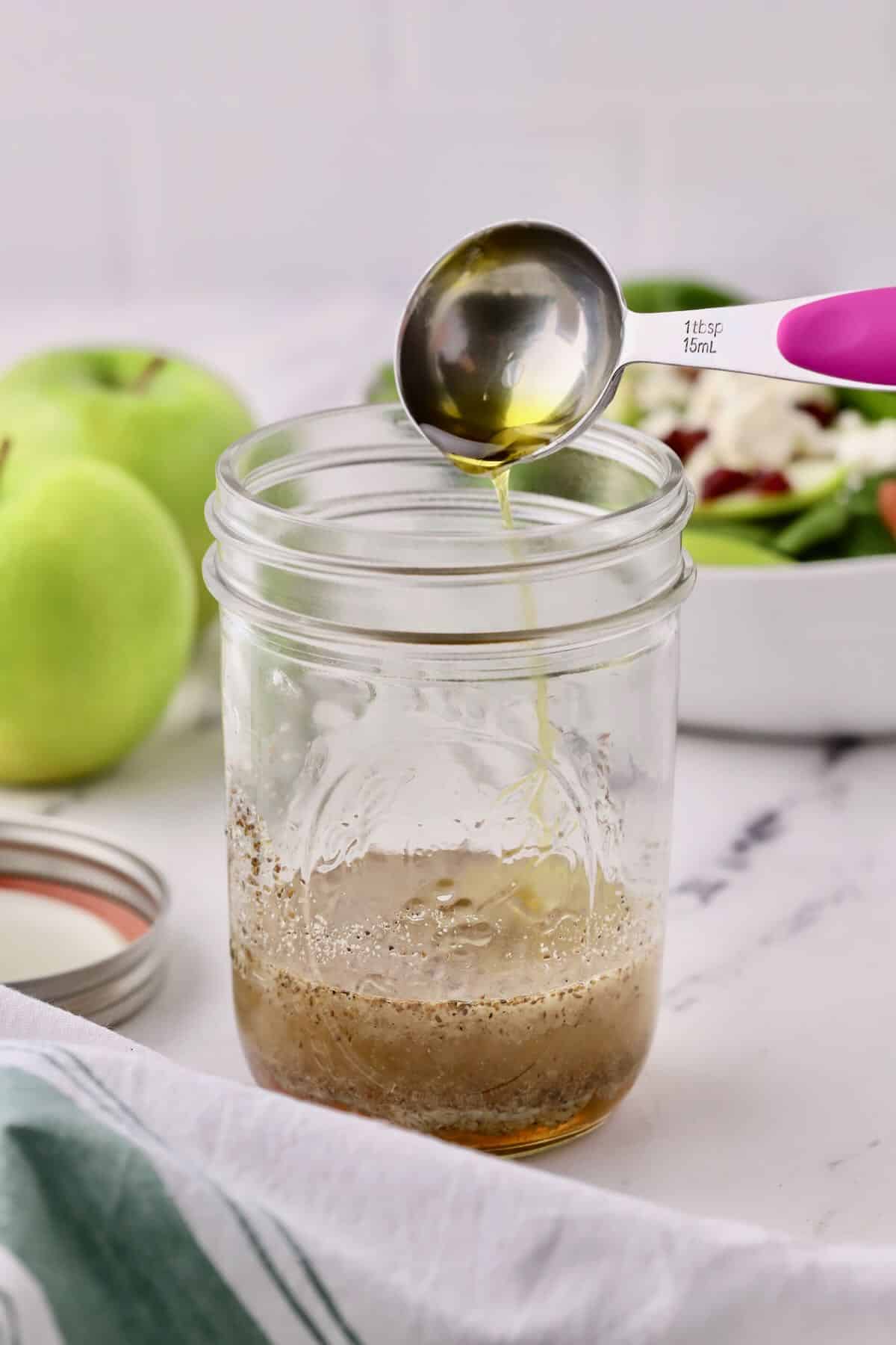 A mason jar with poppy seed dressing. 