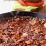 A cast-iron skillet full of smoked baked beans.