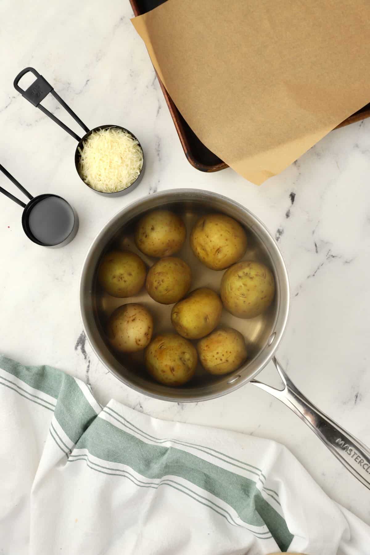 Baby potatoes in a saucepan with water. 