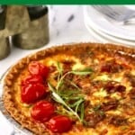 Pinterest pin showing a whole quiche topped with roasted tomatoes and fresh rosemary.
