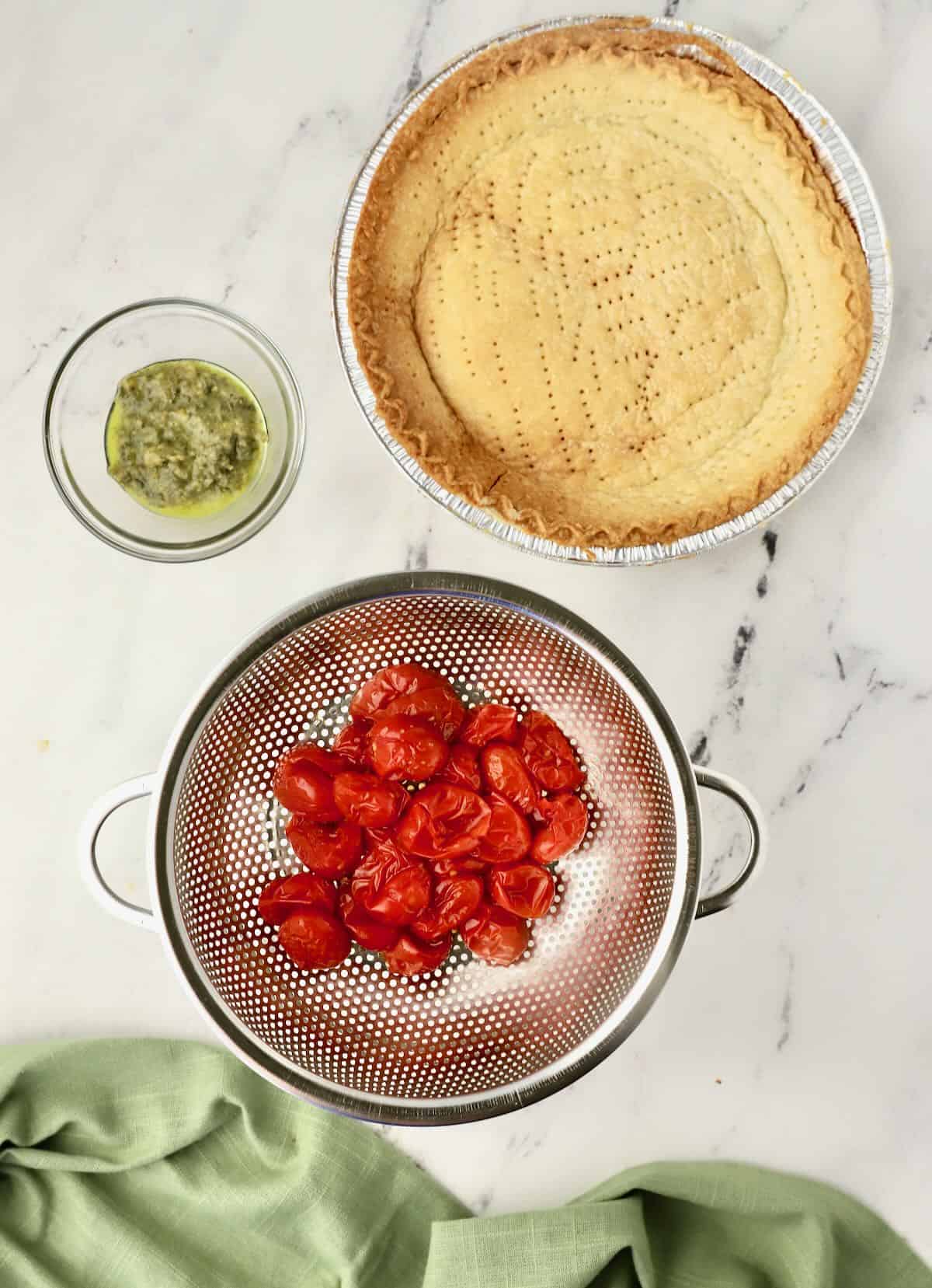 Roasted cherry tomatoes in a colander, draining any excess liquid. 